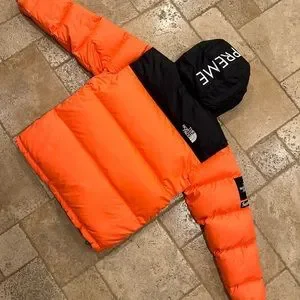Orange supreme north face discount